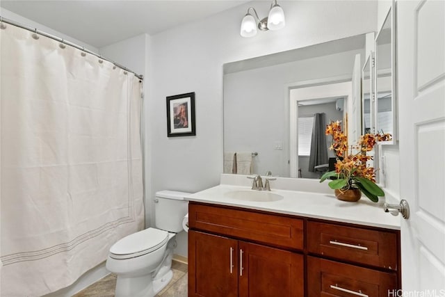 bathroom with vanity, tile patterned flooring, and toilet