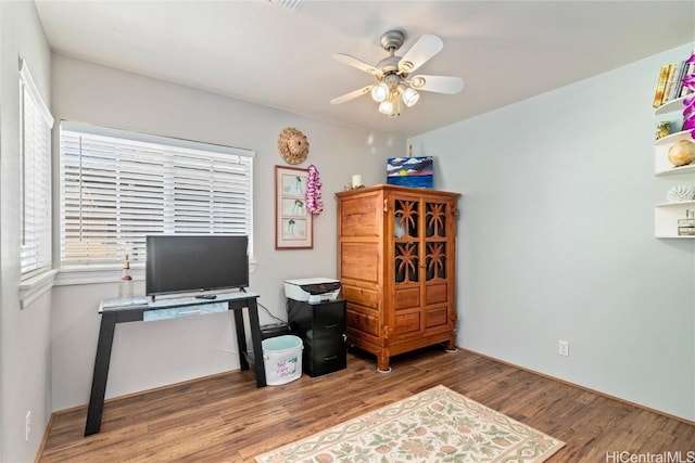 home office featuring wood-type flooring and ceiling fan