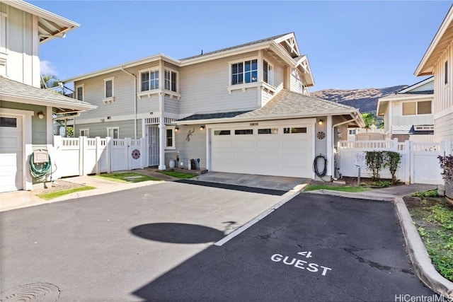 view of front of house featuring a garage and a mountain view