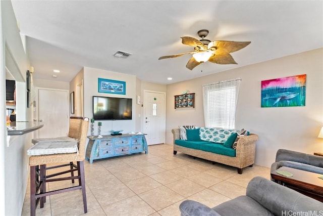 tiled living room with ceiling fan