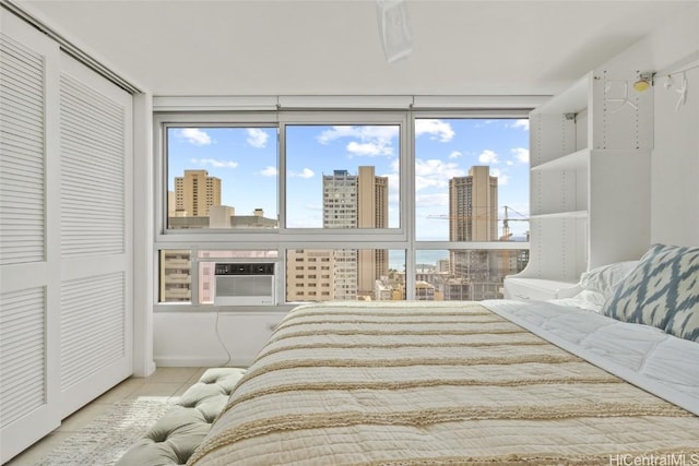 tiled bedroom featuring a closet, cooling unit, and multiple windows