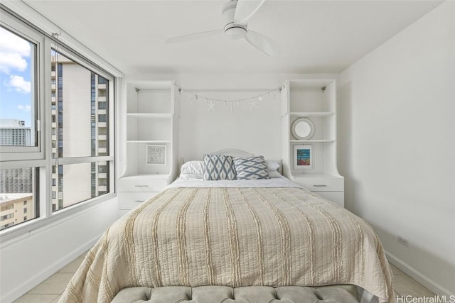 bedroom with ceiling fan and light tile patterned flooring