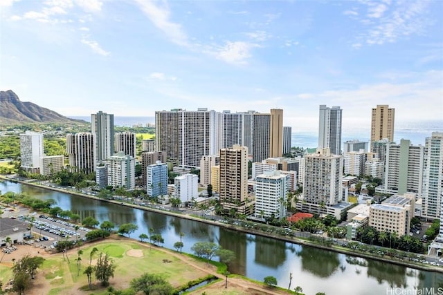 property's view of city with a water and mountain view