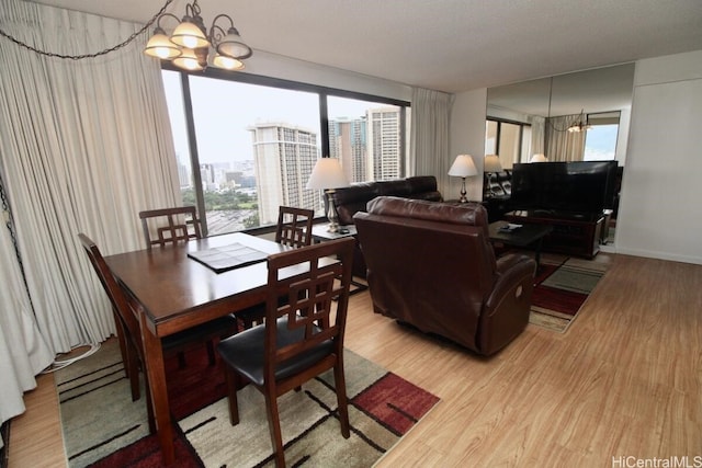 dining area with hardwood / wood-style floors and a notable chandelier