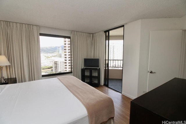 bedroom with wood-type flooring and a textured ceiling