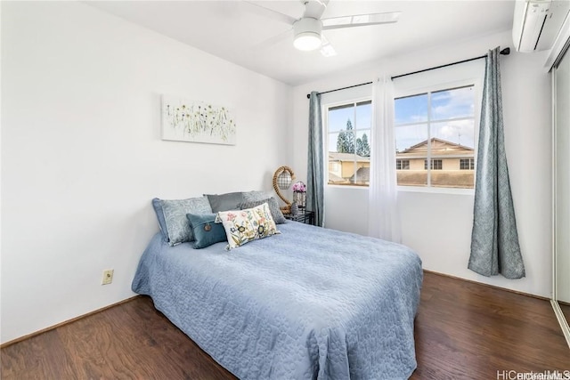 bedroom featuring an AC wall unit, dark hardwood / wood-style floors, and ceiling fan