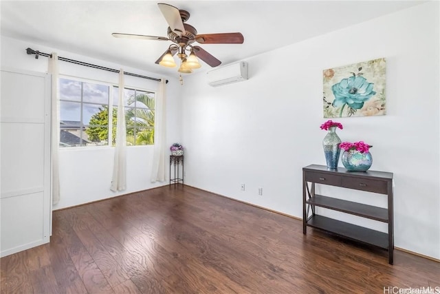 spare room featuring dark hardwood / wood-style floors, an AC wall unit, and ceiling fan