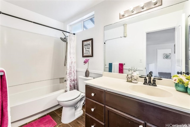 full bathroom with shower / bath combo with shower curtain, toilet, and vanity