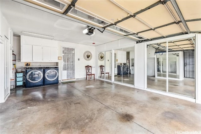 garage with a garage door opener and washer and clothes dryer