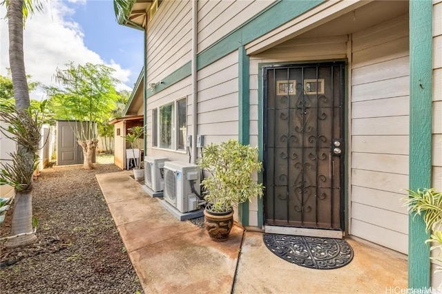 entrance to property with ac unit and a patio