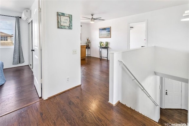 corridor with dark wood-type flooring and a wall unit AC