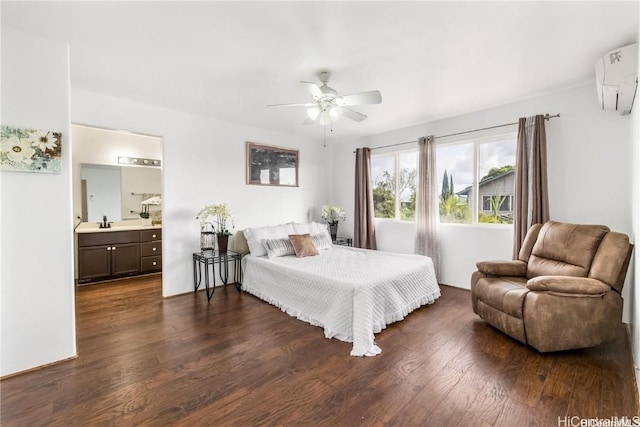 bedroom featuring ensuite bath, dark wood-type flooring, sink, ceiling fan, and a wall mounted air conditioner