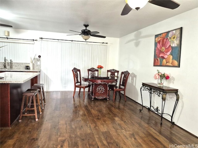 dining room with ceiling fan, sink, and dark hardwood / wood-style floors