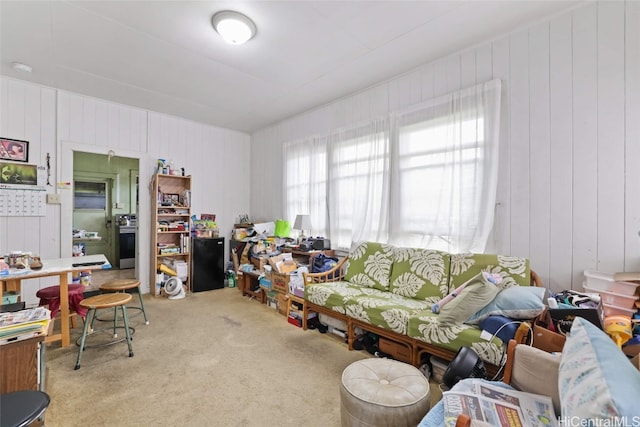 living room with carpet and wood walls