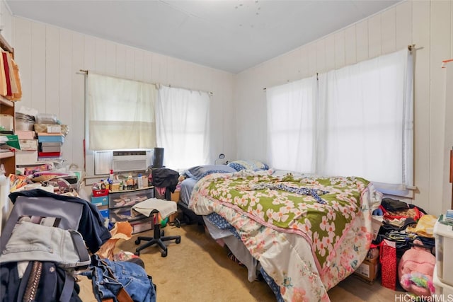 bedroom featuring cooling unit and wooden walls