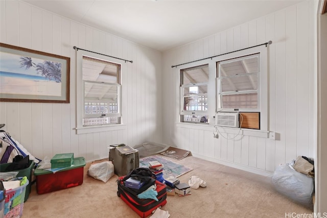 miscellaneous room featuring cooling unit, light colored carpet, and wooden walls