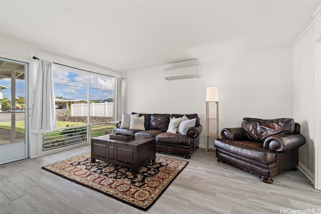 living room featuring a wall mounted air conditioner, crown molding, and light hardwood / wood-style floors