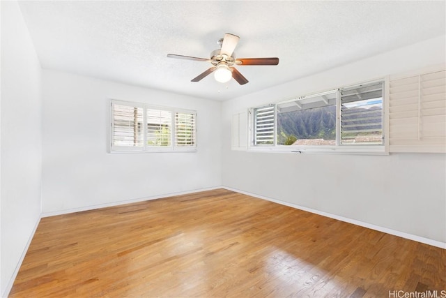 spare room featuring ceiling fan, a textured ceiling, and light hardwood / wood-style floors