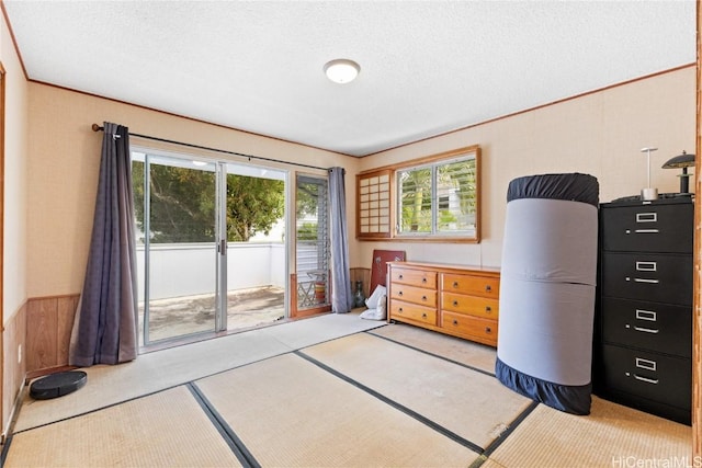 bedroom featuring access to exterior and a textured ceiling