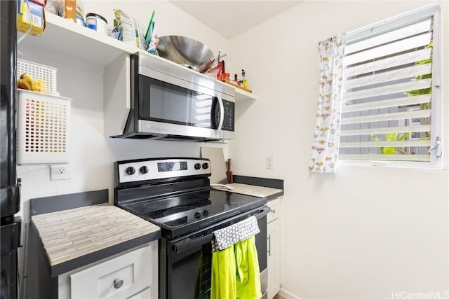 kitchen featuring white cabinetry and appliances with stainless steel finishes