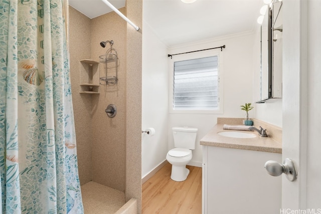 bathroom with toilet, a shower with curtain, ornamental molding, vanity, and hardwood / wood-style flooring