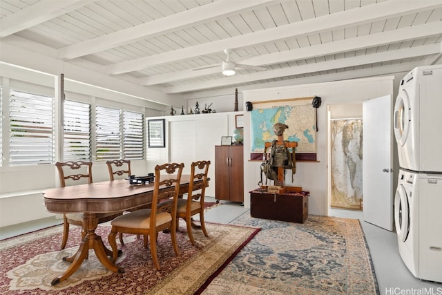 dining area featuring stacked washer / dryer, wood ceiling, and beamed ceiling