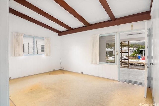 carpeted spare room with lofted ceiling with beams