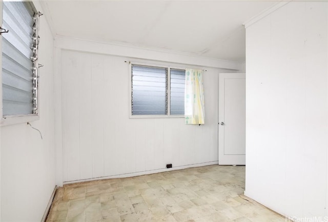 spare room with crown molding