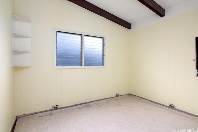 empty room with vaulted ceiling with beams