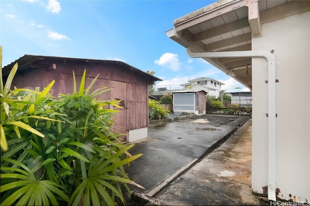 view of property exterior featuring a storage unit