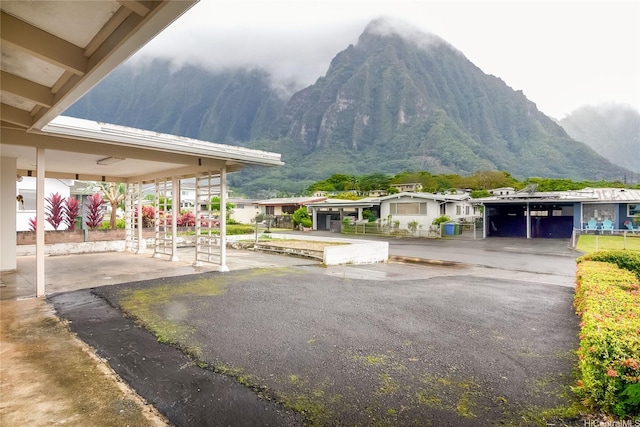 view of community with a mountain view and a carport