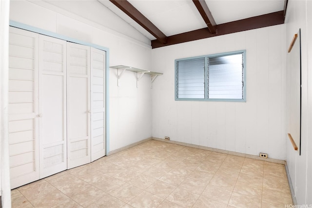 unfurnished bedroom with beamed ceiling
