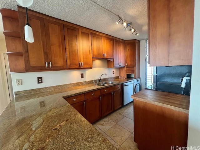 kitchen with decorative light fixtures, dishwasher, sink, dark stone countertops, and a textured ceiling