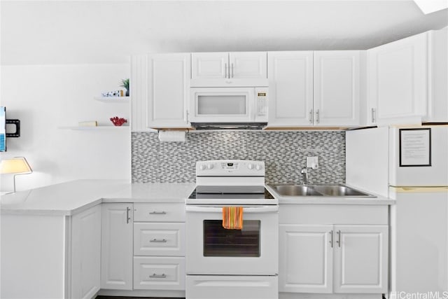 kitchen featuring tasteful backsplash, white cabinetry, sink, and white appliances