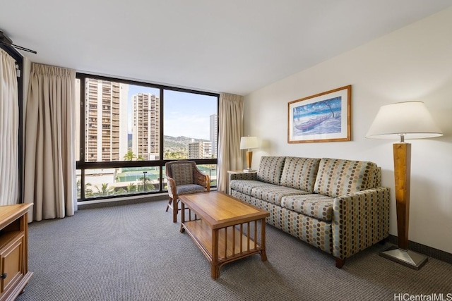 carpeted living room with a view of city and a wall of windows