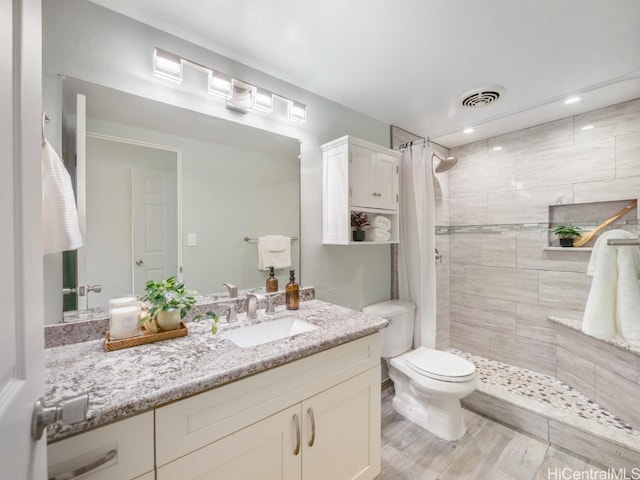 bathroom with vanity, a shower with curtain, and toilet