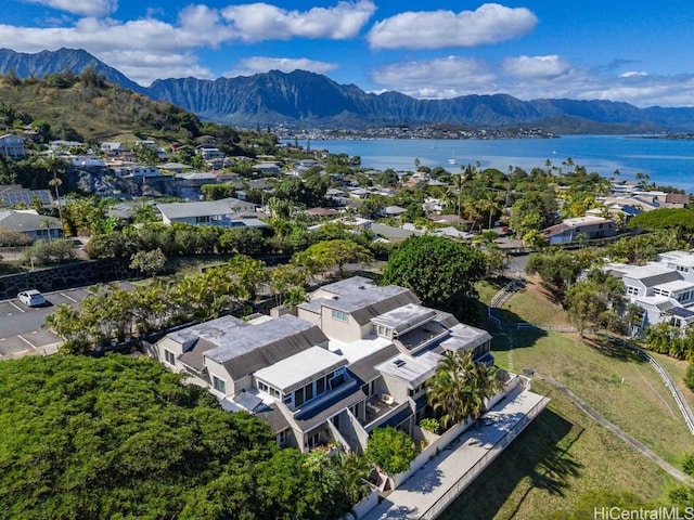 birds eye view of property with a water and mountain view