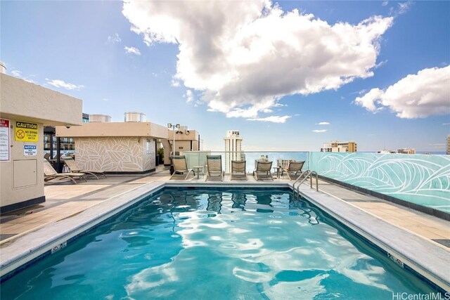 community pool with a patio area