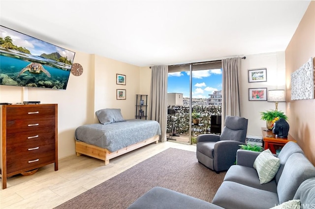 bedroom featuring expansive windows and access to exterior