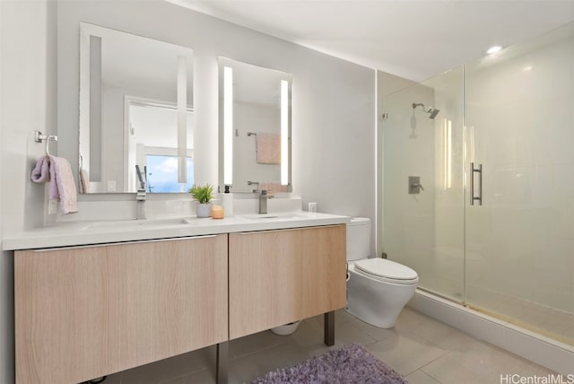 bathroom with a shower with door, toilet, tile patterned floors, and vanity