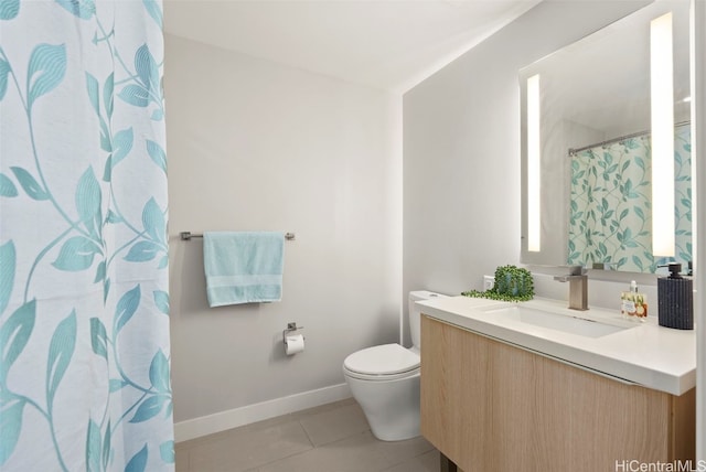 bathroom with vanity, toilet, and tile patterned flooring