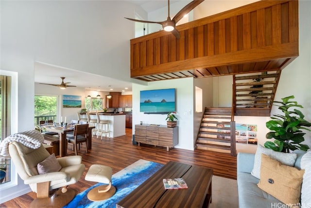 living room with ceiling fan, hardwood / wood-style floors, and high vaulted ceiling