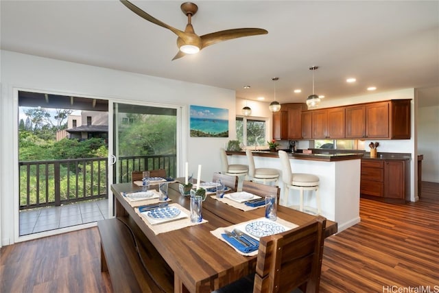 dining room featuring plenty of natural light, ceiling fan, and dark hardwood / wood-style flooring