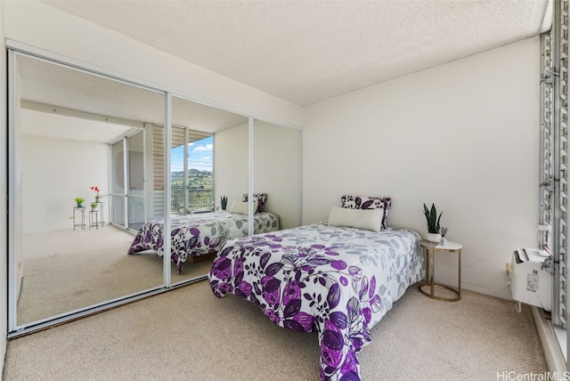 bedroom with carpet, a closet, and a textured ceiling