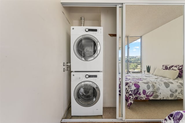 laundry room featuring stacked washer and clothes dryer