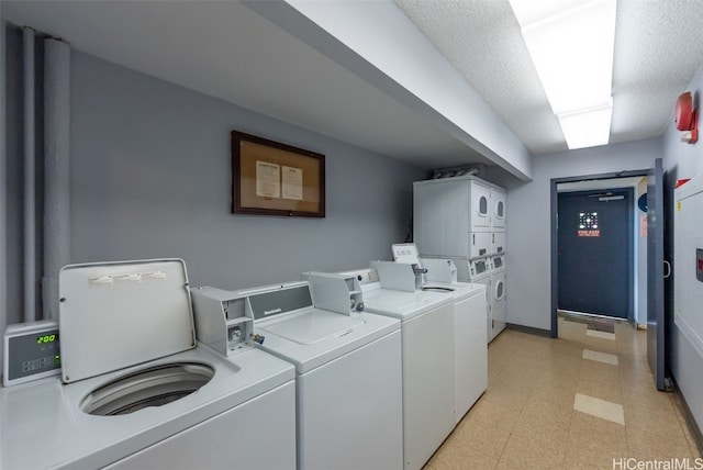 laundry room with stacked washer and dryer, a textured ceiling, and independent washer and dryer