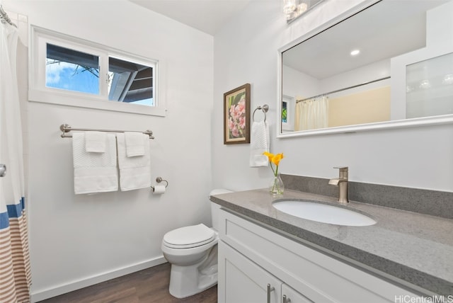 bathroom with vanity, hardwood / wood-style floors, and toilet