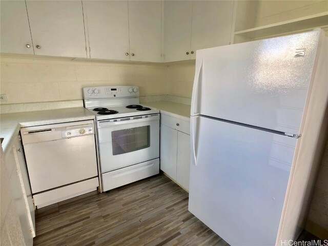 kitchen featuring white appliances, dark hardwood / wood-style flooring, and white cabinets