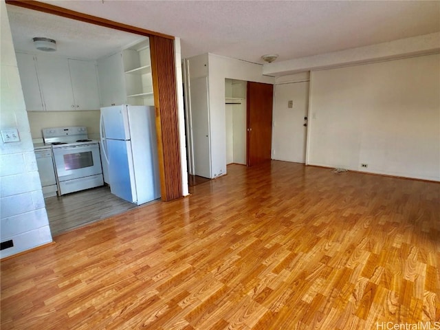 kitchen featuring white cabinets, white appliances, and light hardwood / wood-style floors