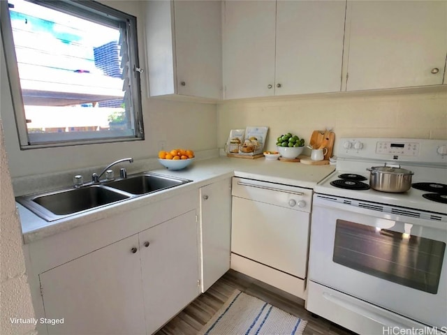 kitchen with white cabinetry, sink, white appliances, and dark hardwood / wood-style flooring